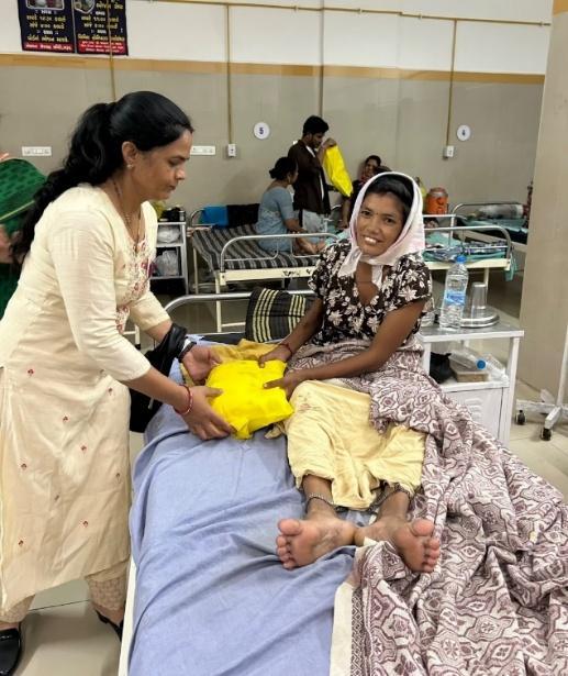 RCB Femina members distributing nutrition kits to new mothers